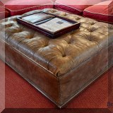 F33. Tufted leather ottoman with nailhead trim. 18”h x 48”w x 36”d 